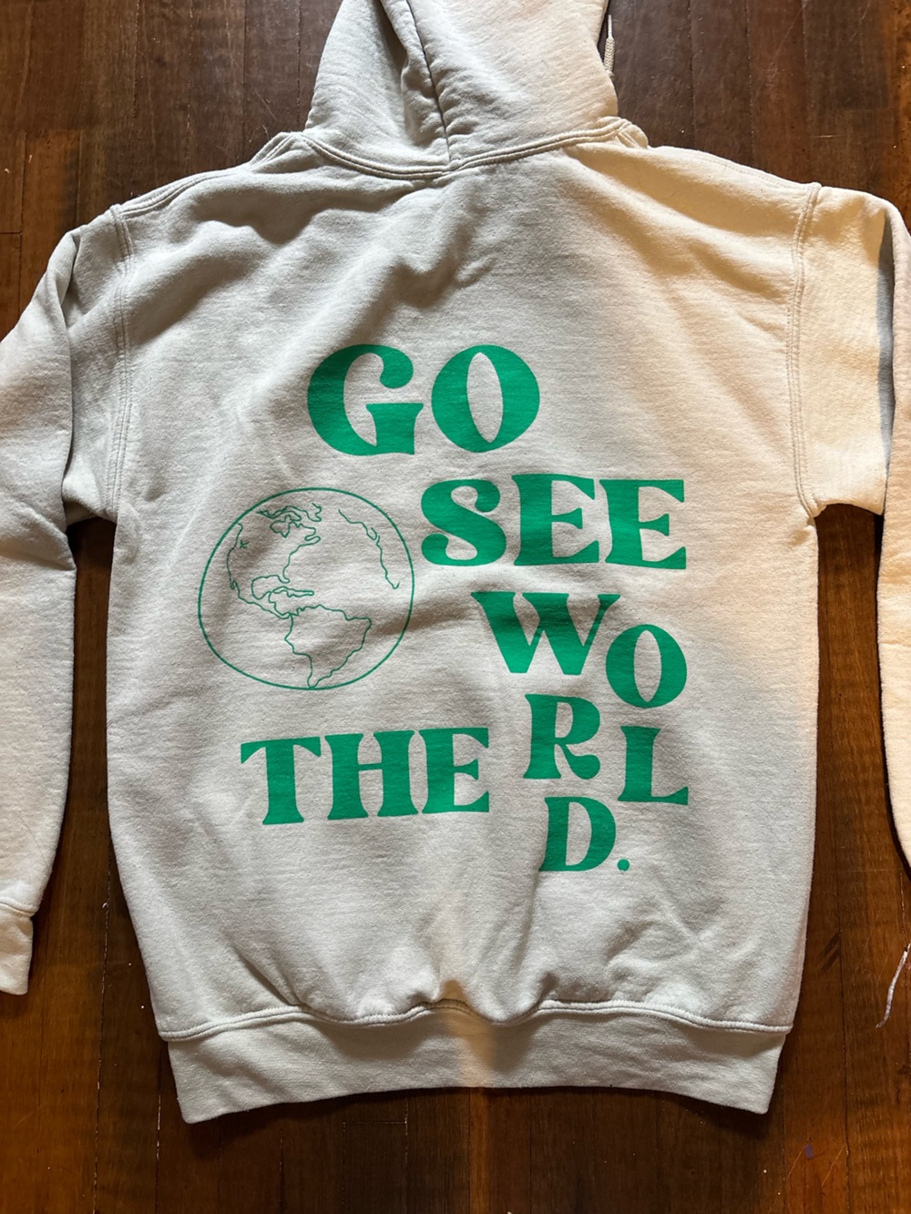 Cream Hoodie with Green "GO SEE THE WORLD" Graphic